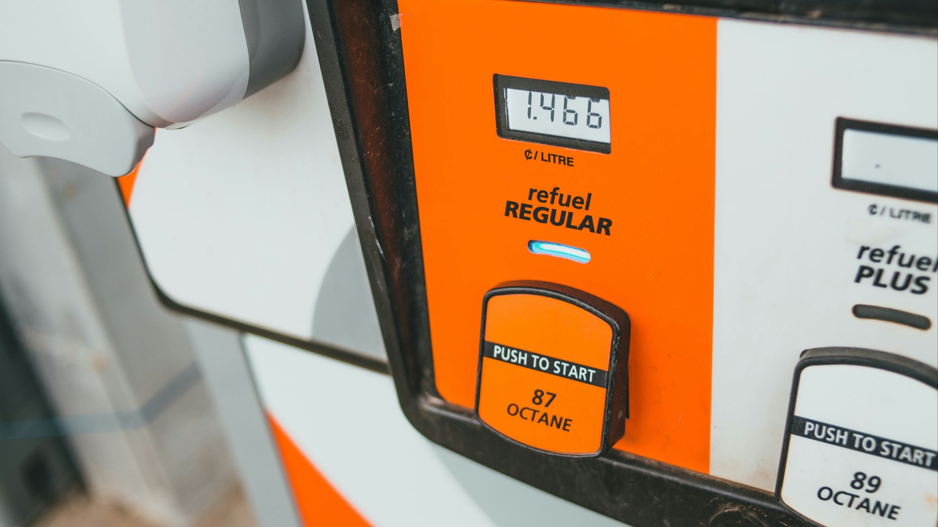 a close up of an orange and white gas pump