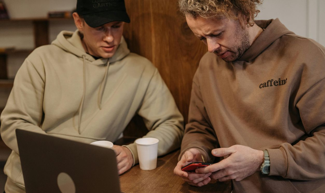men Looking at a Smartphone Together