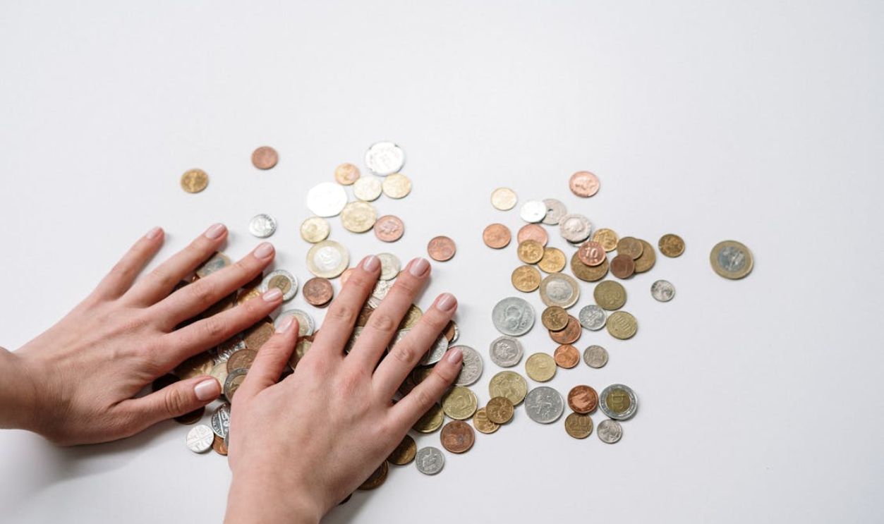 Person Holding Silver Round Coins
