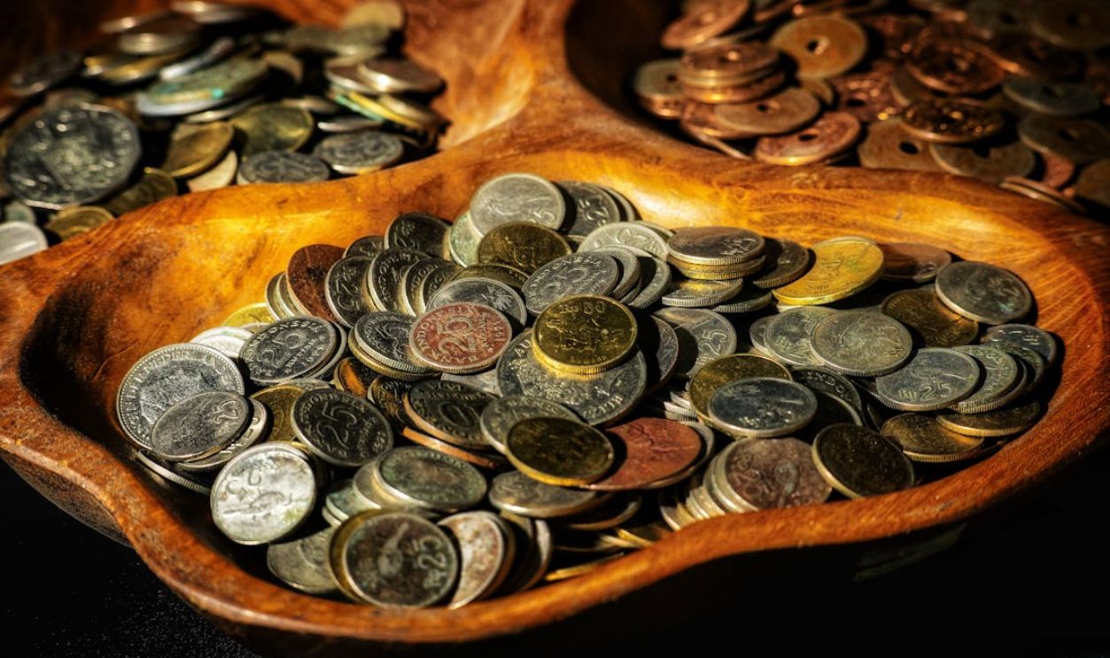 Collection of Indonesian Coins in Wooden Bowls