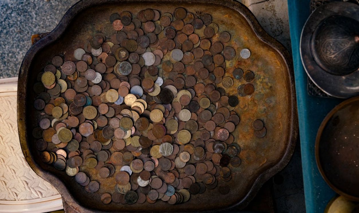 A tray filled with coins and other items