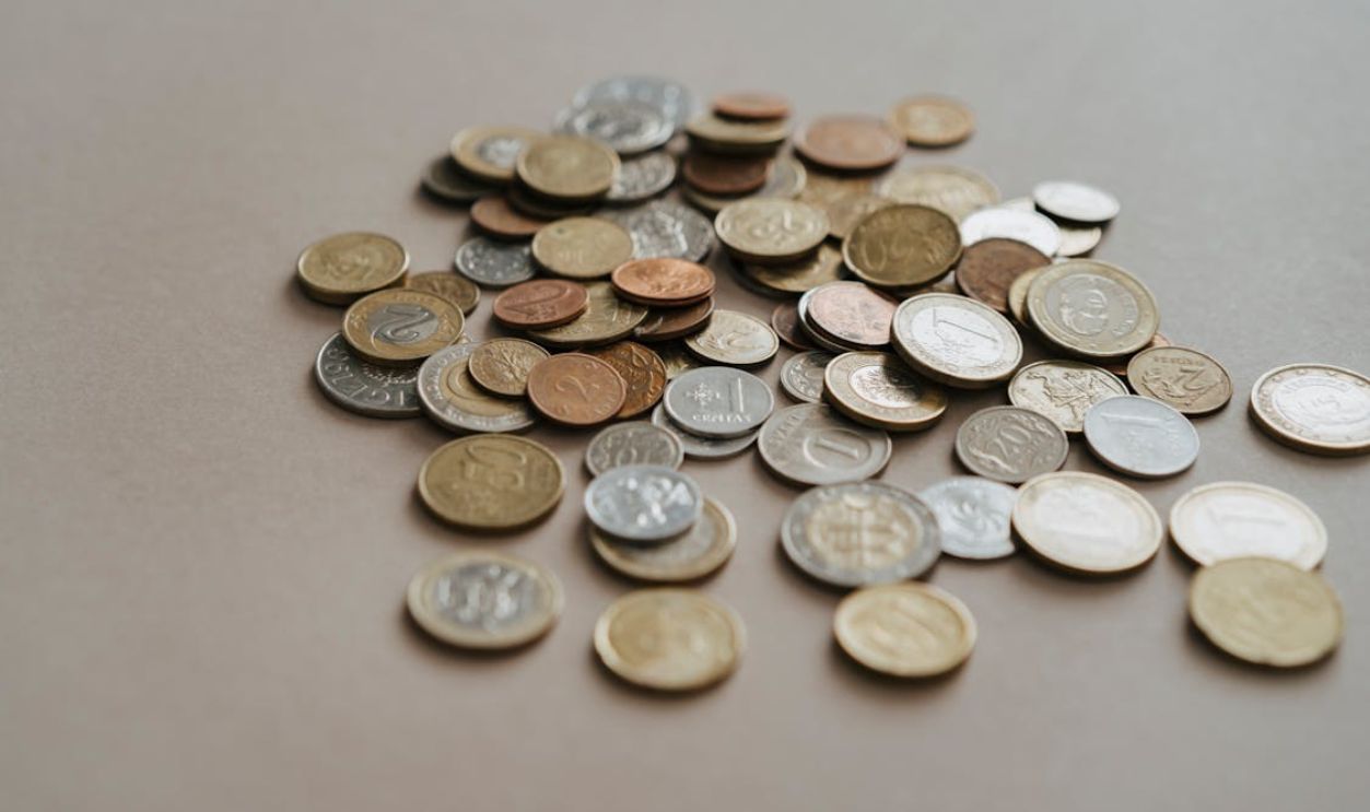 Silver and Gold Round Coins on the Table