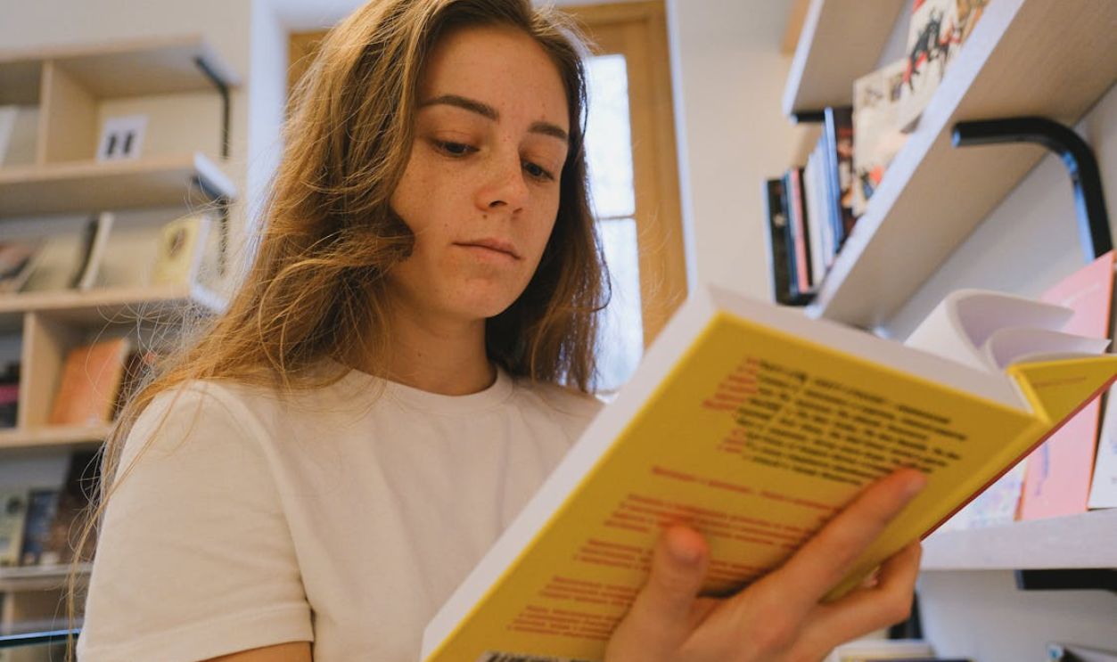 Low-Angle Shot of a Woman Holding a Book