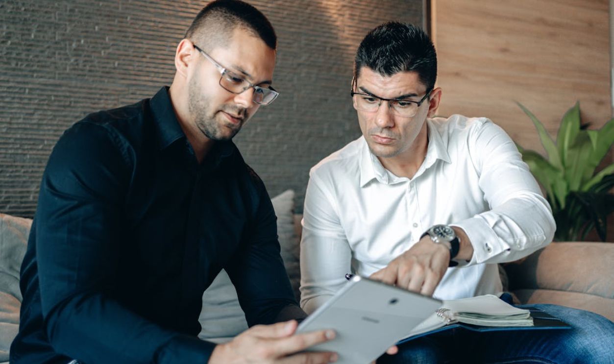 A Two Men Wearing Eyeglasses Looking the Digital Tablet