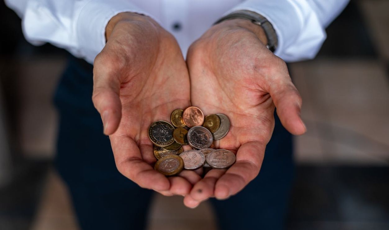 Hands Holding Argentine Peso Coins Closeup