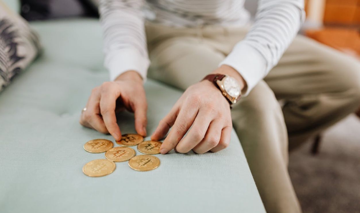 Hands Holding Gold Round Coins