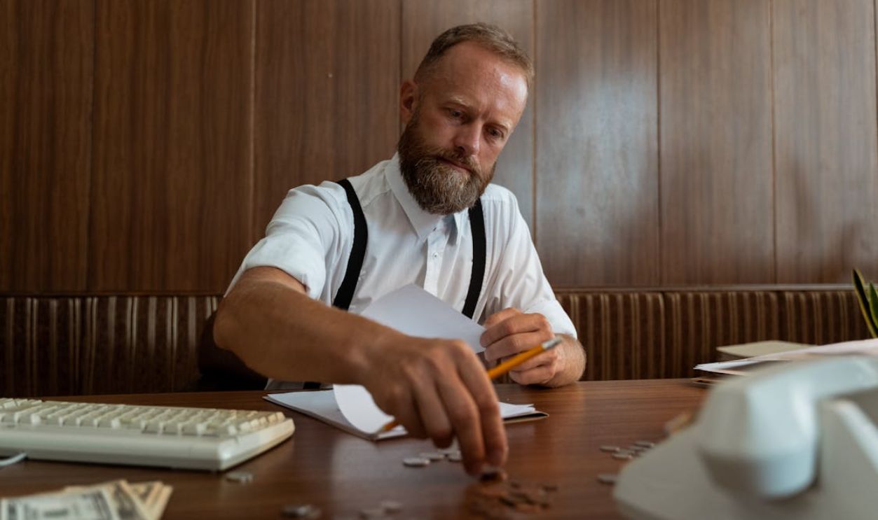 A Man Counting Coins