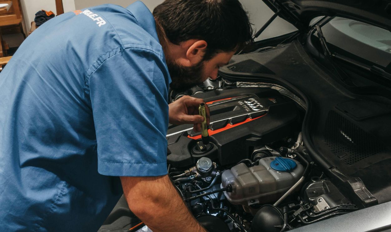 A Mechanic Checking the Engine of the Car