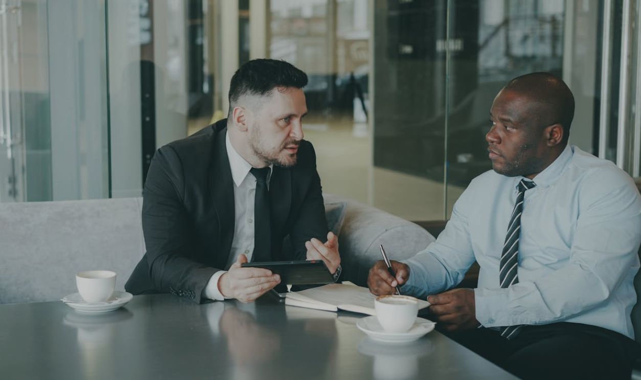 Two Businessmen Discussing Ideas in Meeting