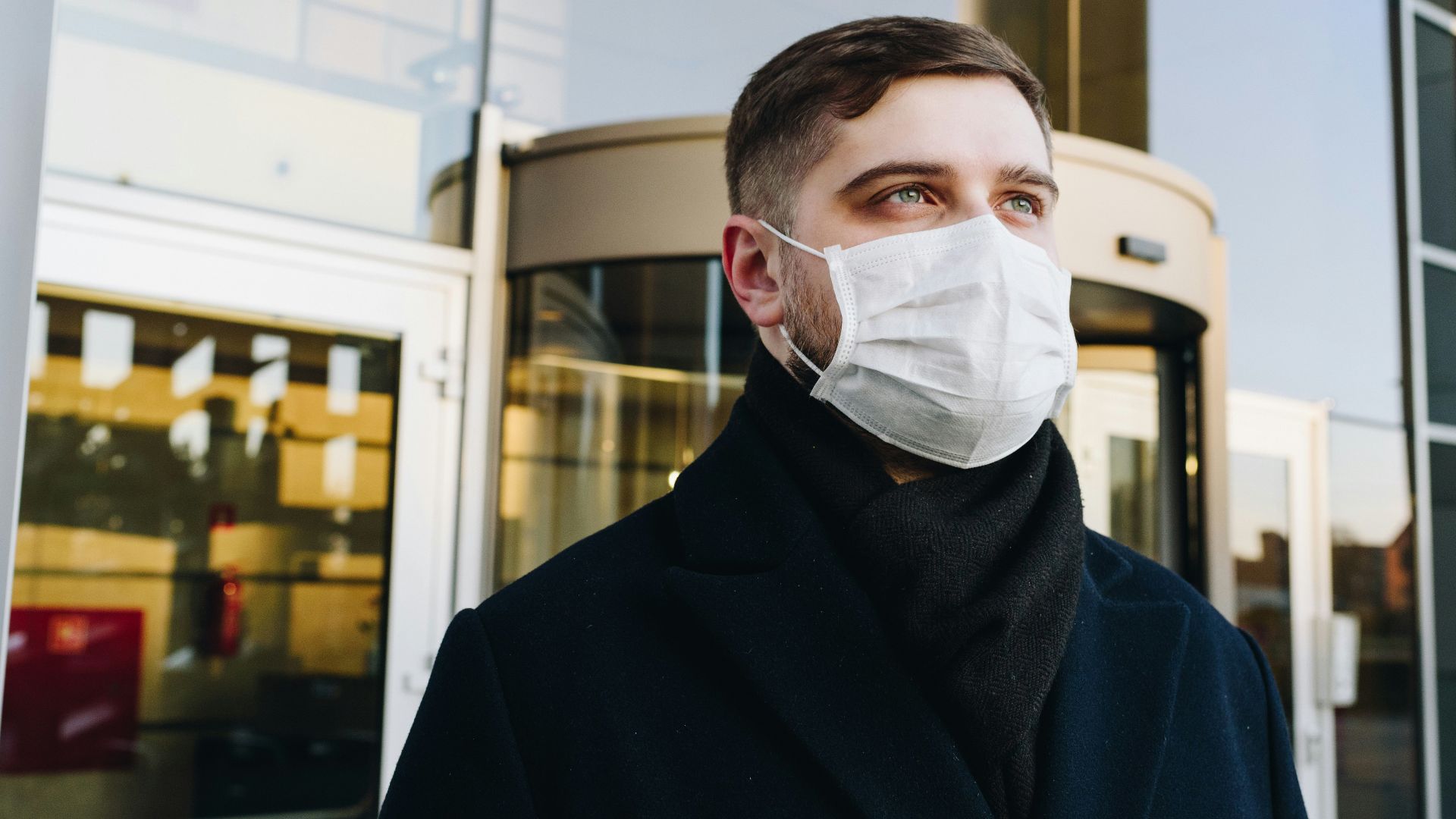 man in black robe wearing white face mask