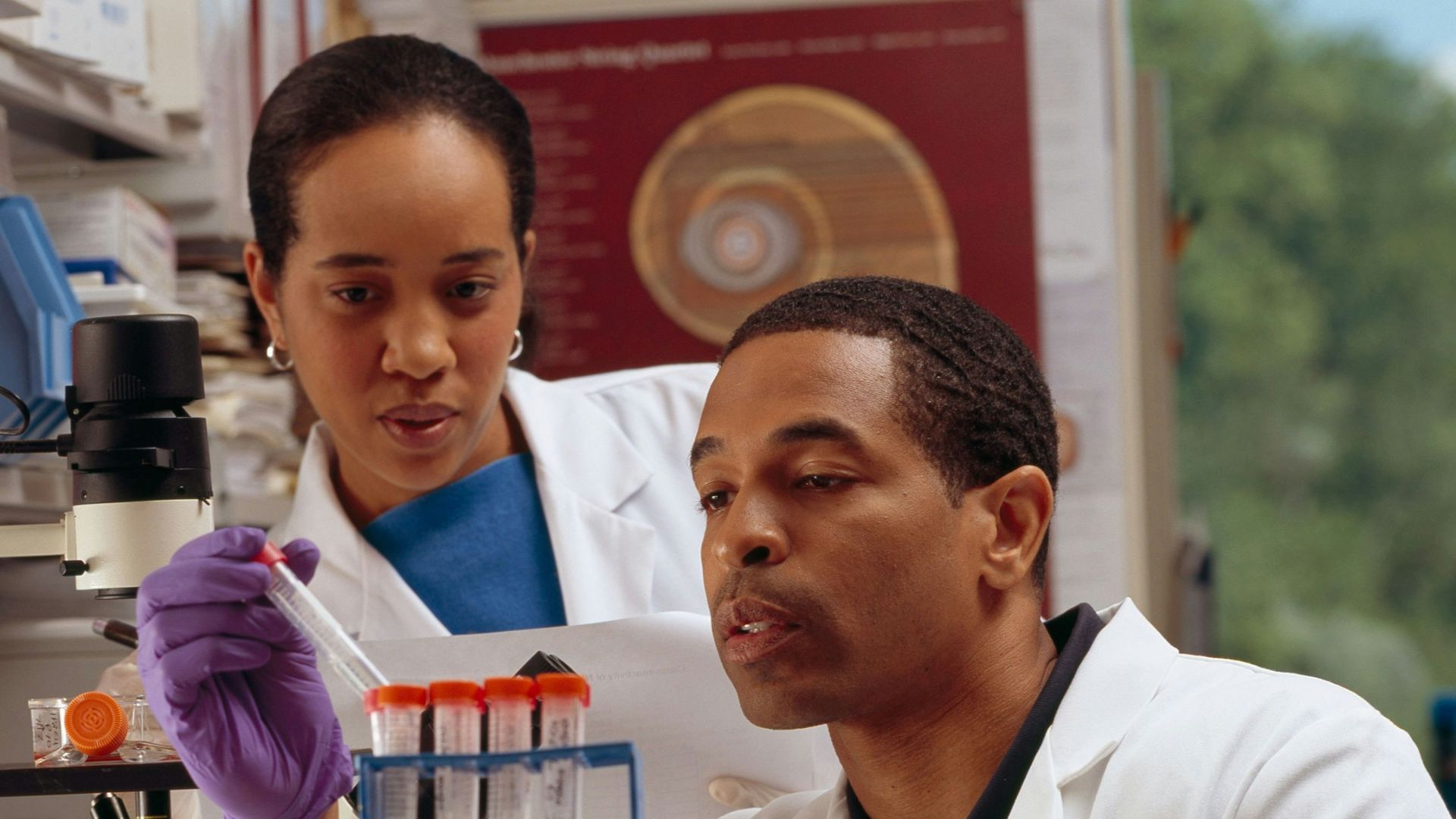 man in white chef uniform holding purple plastic bottle