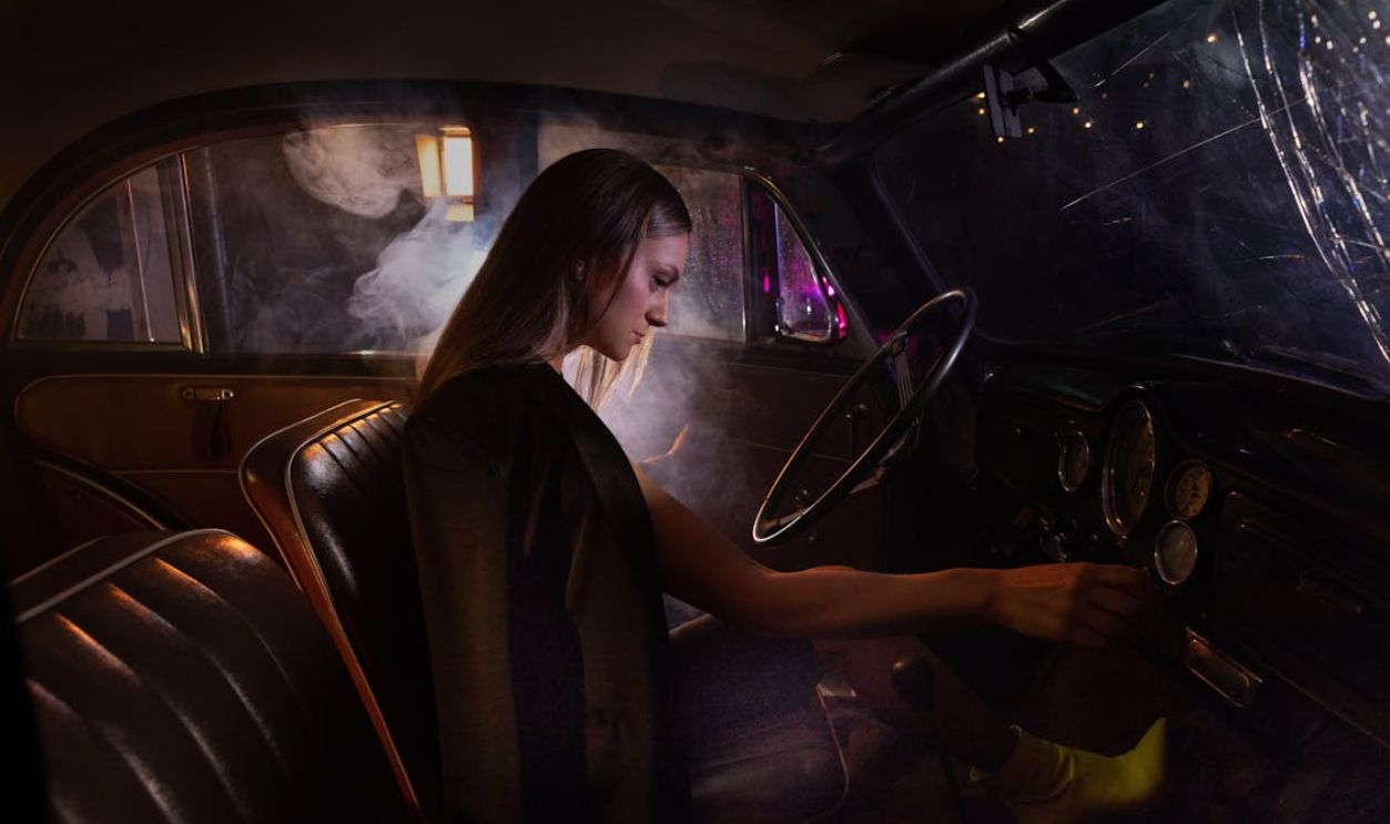 A Woman Starting the Engine of Her Car