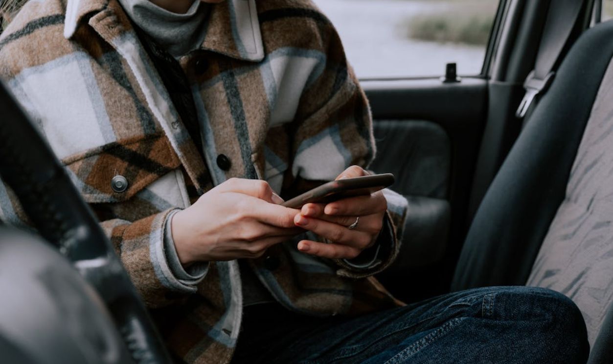 Person Sitting in the Car Using Cellphone