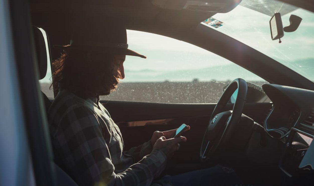 Occupied Man using Phone while on the Driver's Side