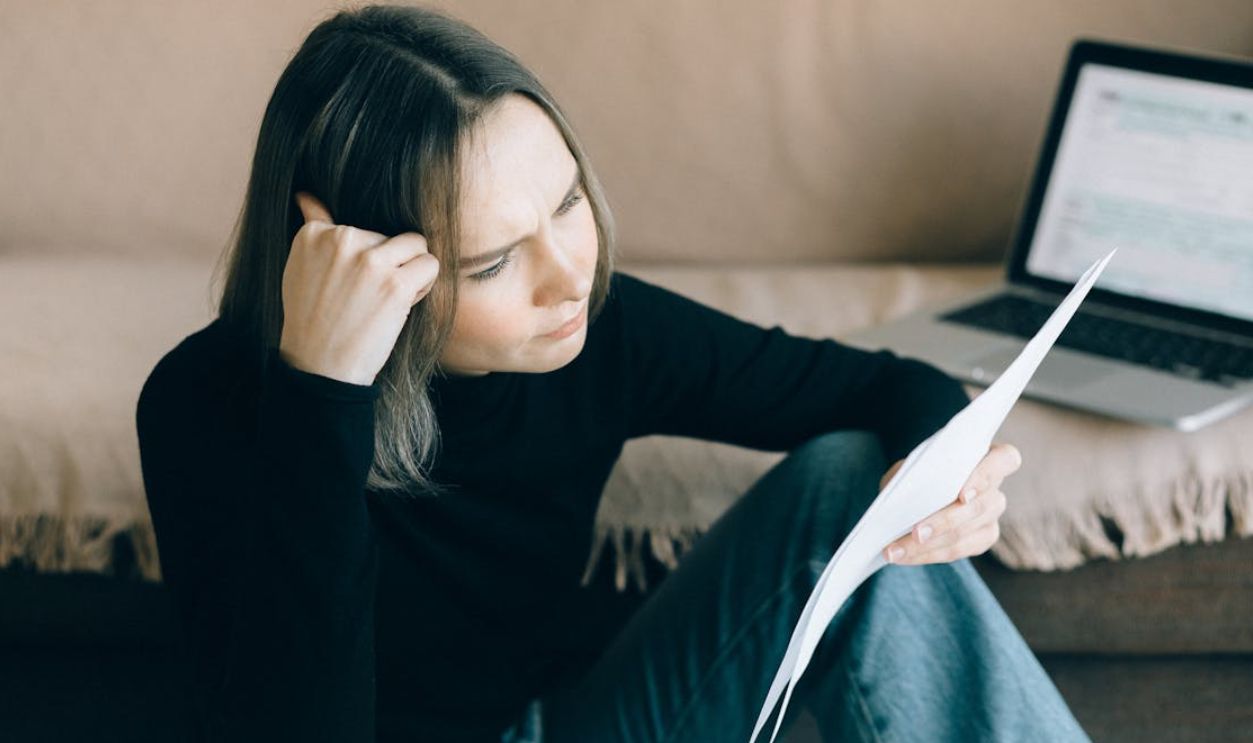 Woman in Black Long Sleeves Shirt Holding Papers