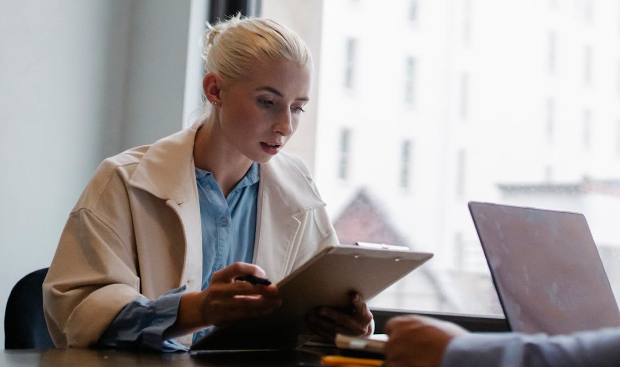 Serious businesswoman reading documents in office