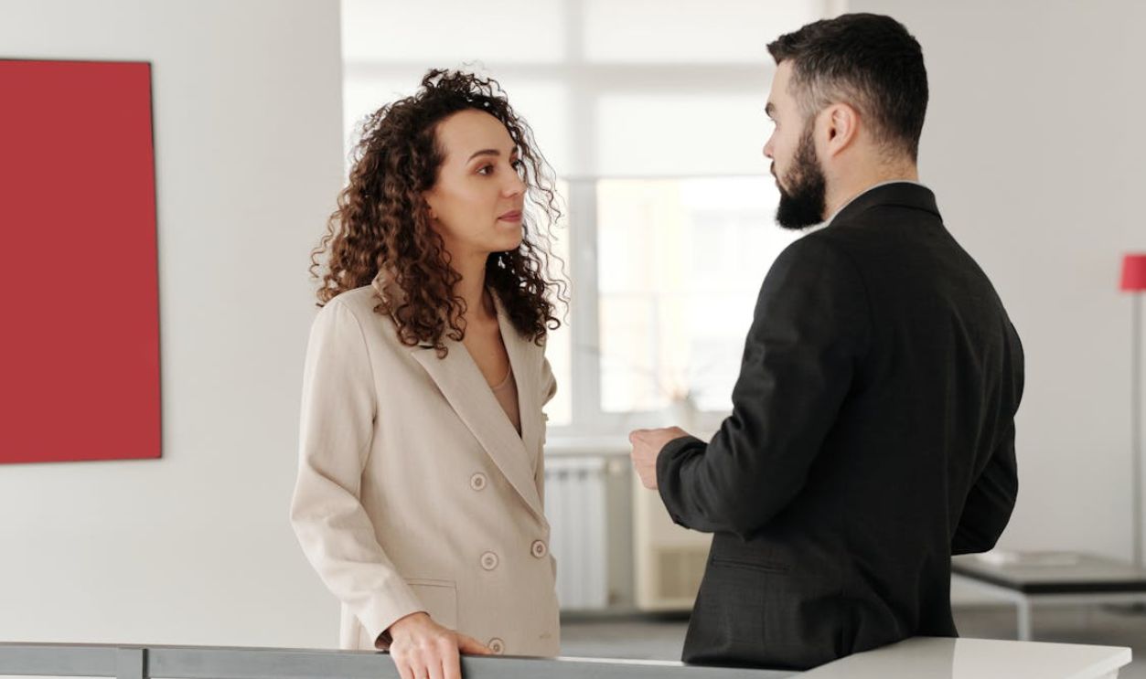 Man and Woman Talking in Office