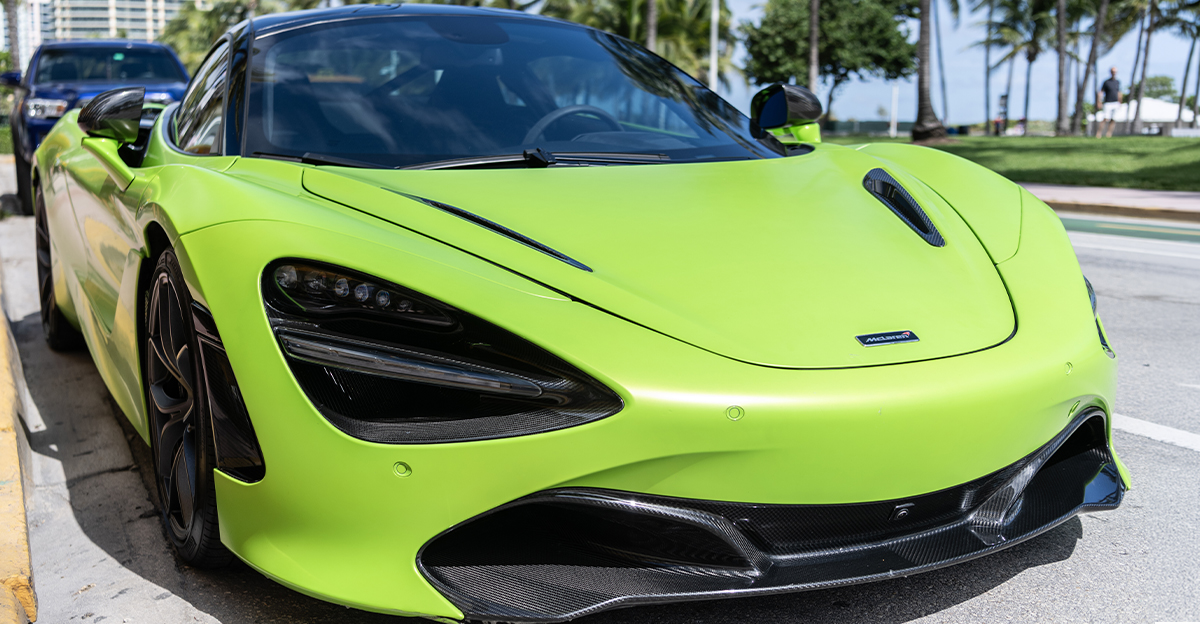 A green McLaren 720S parked outdoors.