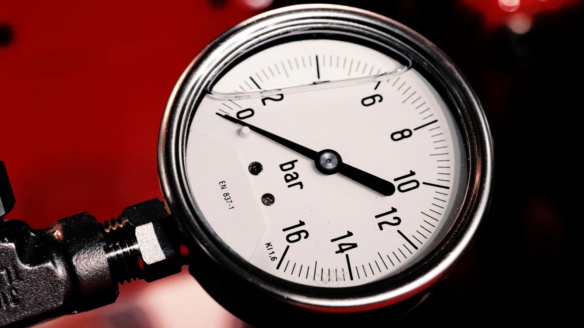 Detailed view of a bar pressure gauge used in industrial settings, emphasizing precision and measurement.