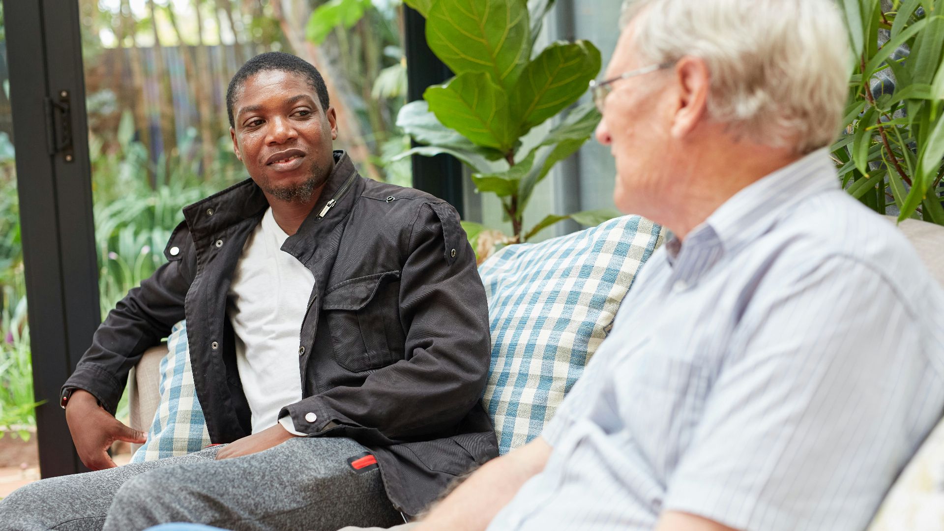 a couple of people sitting on top of a couch