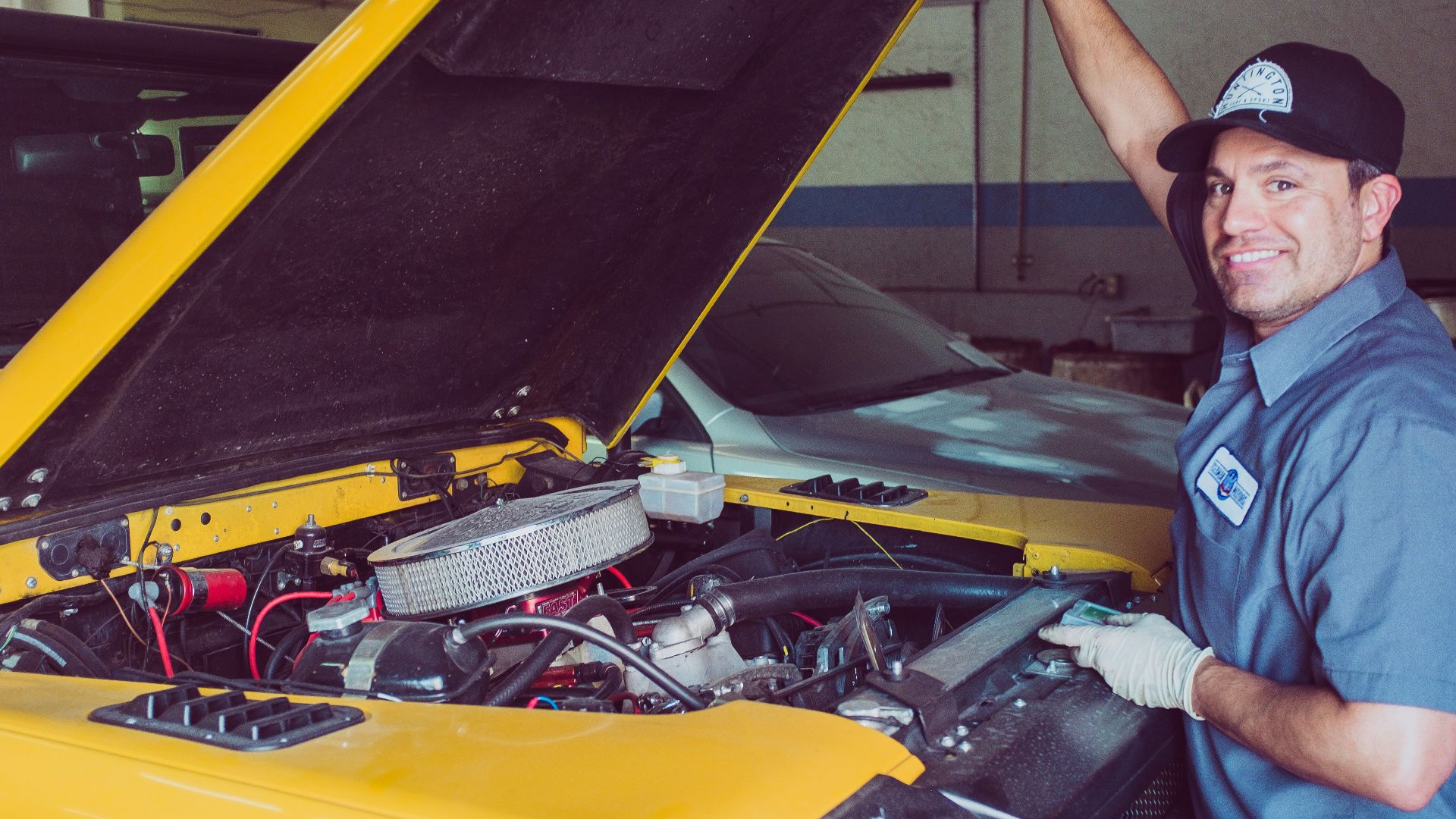 man holding open-wide car trunk
