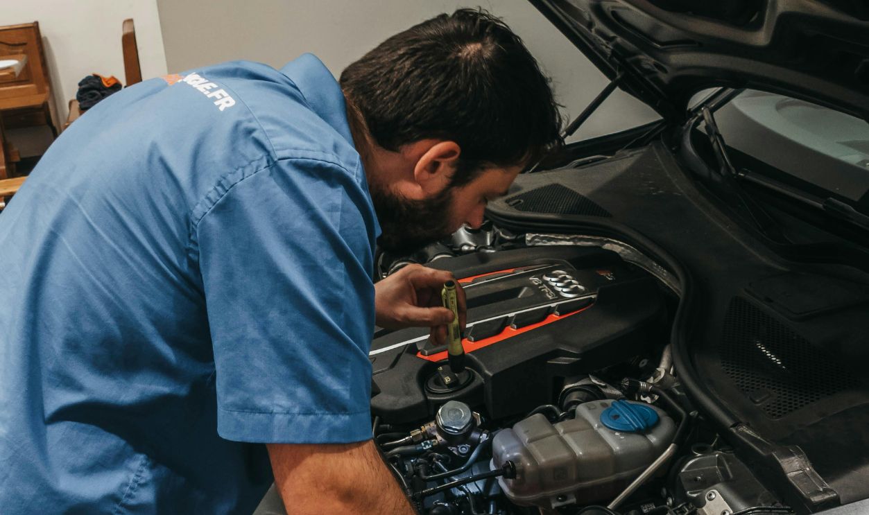 A Mechanic Checking the Engine of the Car