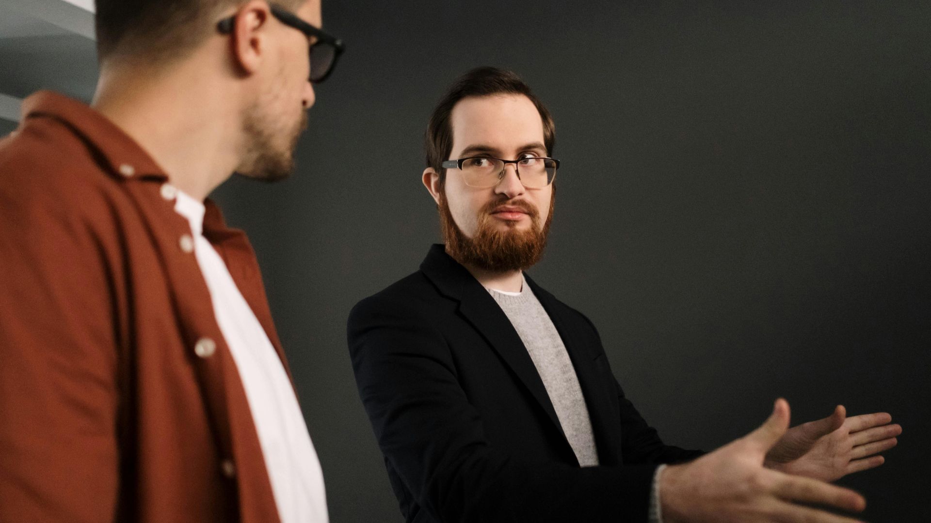 Two businessmen having an in-depth discussion indoors, focusing on collaboration.