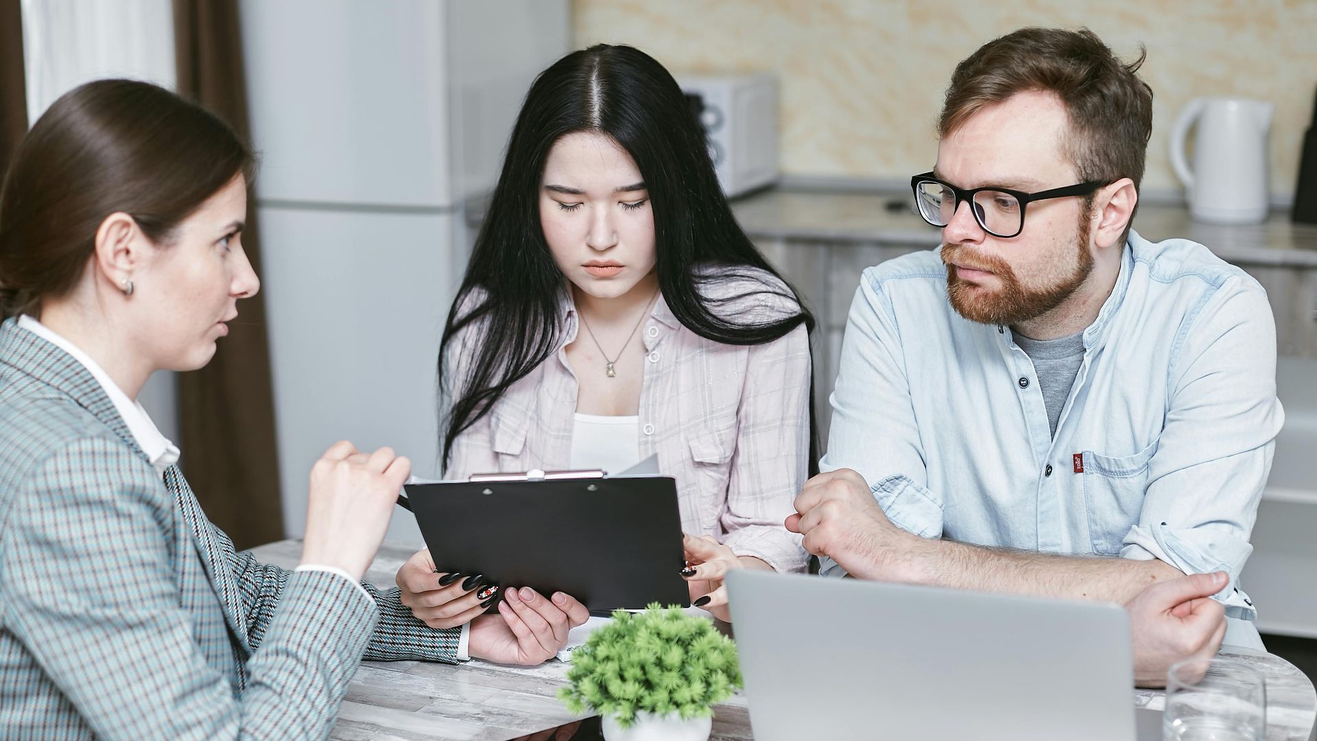 A group of professionals discussing business strategies at a table indoors.