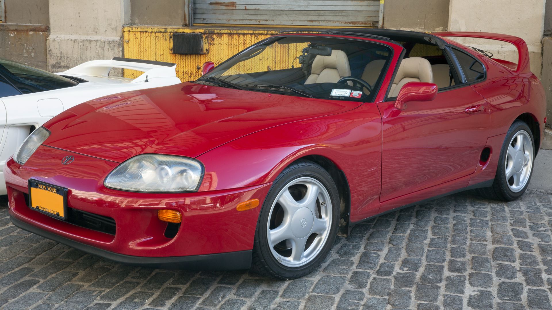 A 1994 Toyota Supra Sport Roof in Red at a car meet in Brooklyn's Industry City.