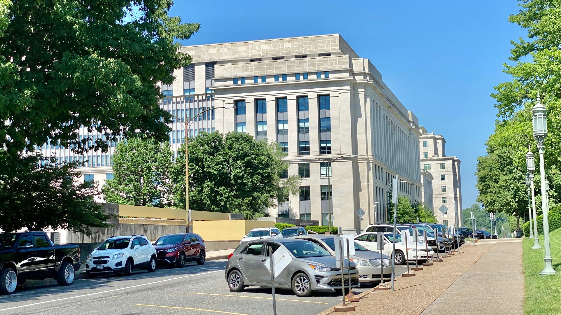 Built in 2000, this Contemporary and Classical Revival-style office building was designed by Bohlin Cywinski Jackson to house additional office space for the state government of Pennsylvania.  The building features a stone panel-clad exterior, doric pilasters, vertical window bays with metal spandrel panels, curtain walls on the east and west facades, a central atrium with a hipped glass roof, setbacks at the top of the building, and an appearance overall reminiscent of 1930s Stripped Classicism that was popular in the United States and other countries.