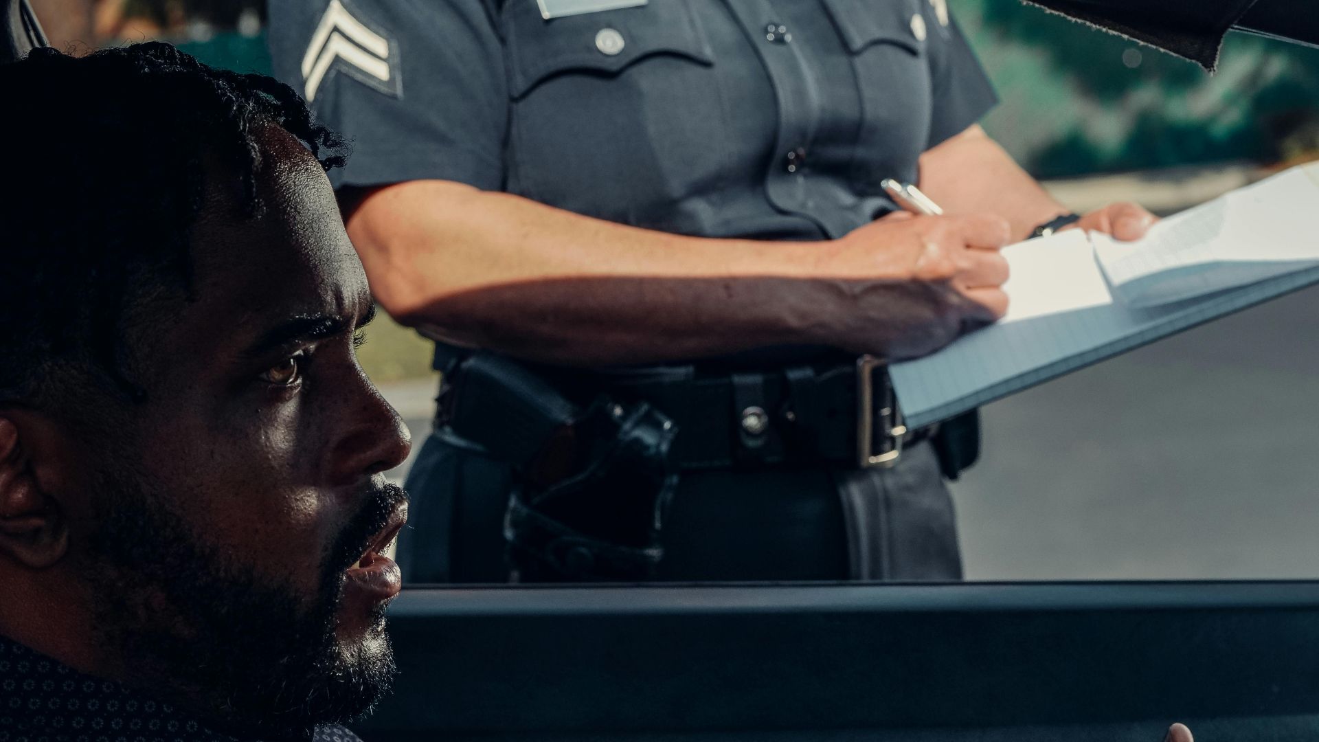 A police officer issuing a ticket to a driver during a traffic stop.