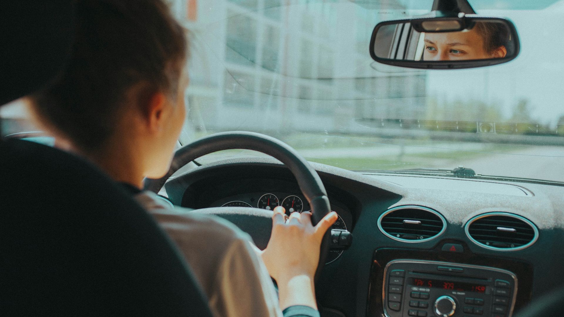 man in black shirt driving car