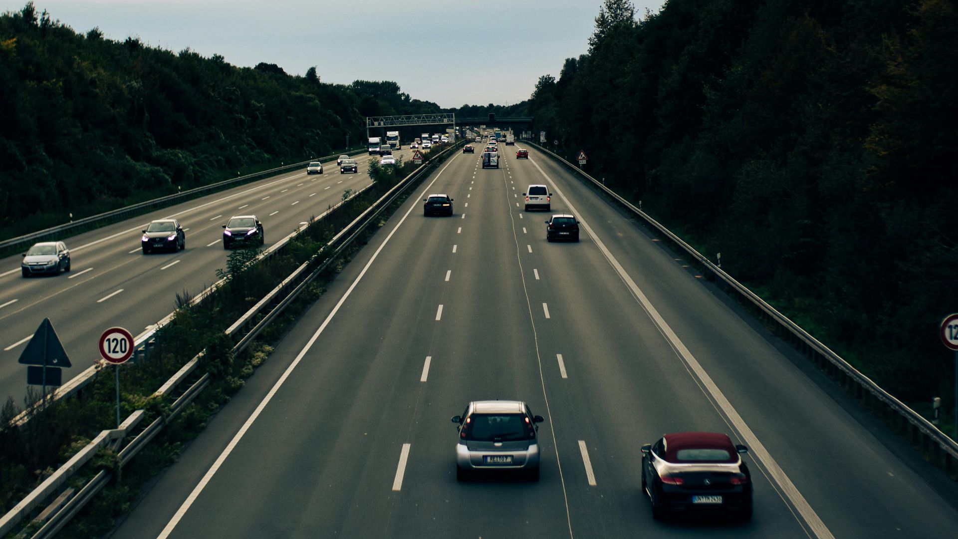 An aerial view of busy highway traffic in Dortmund, Germany with lush greenery.