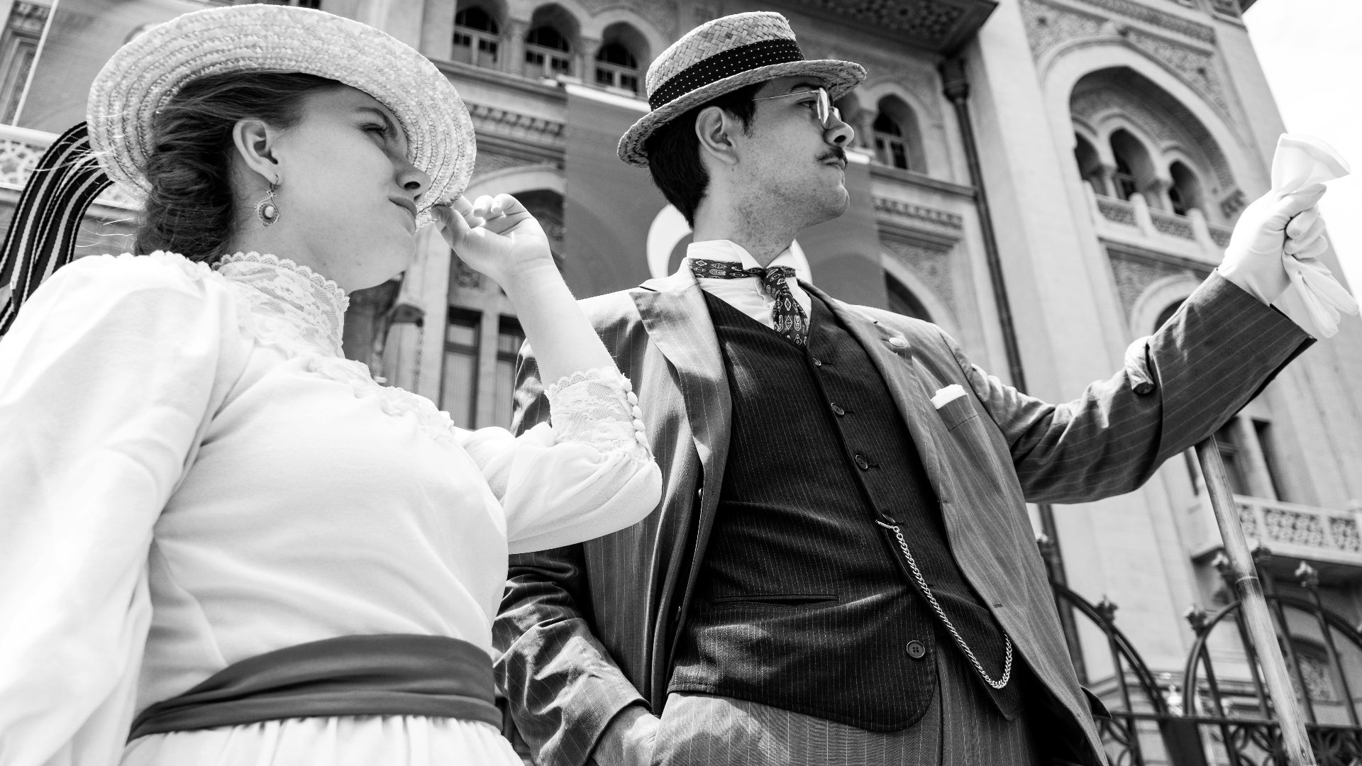 Black and white photo of a well-dressed vintage couple in front of iconic Ankara architecture.
