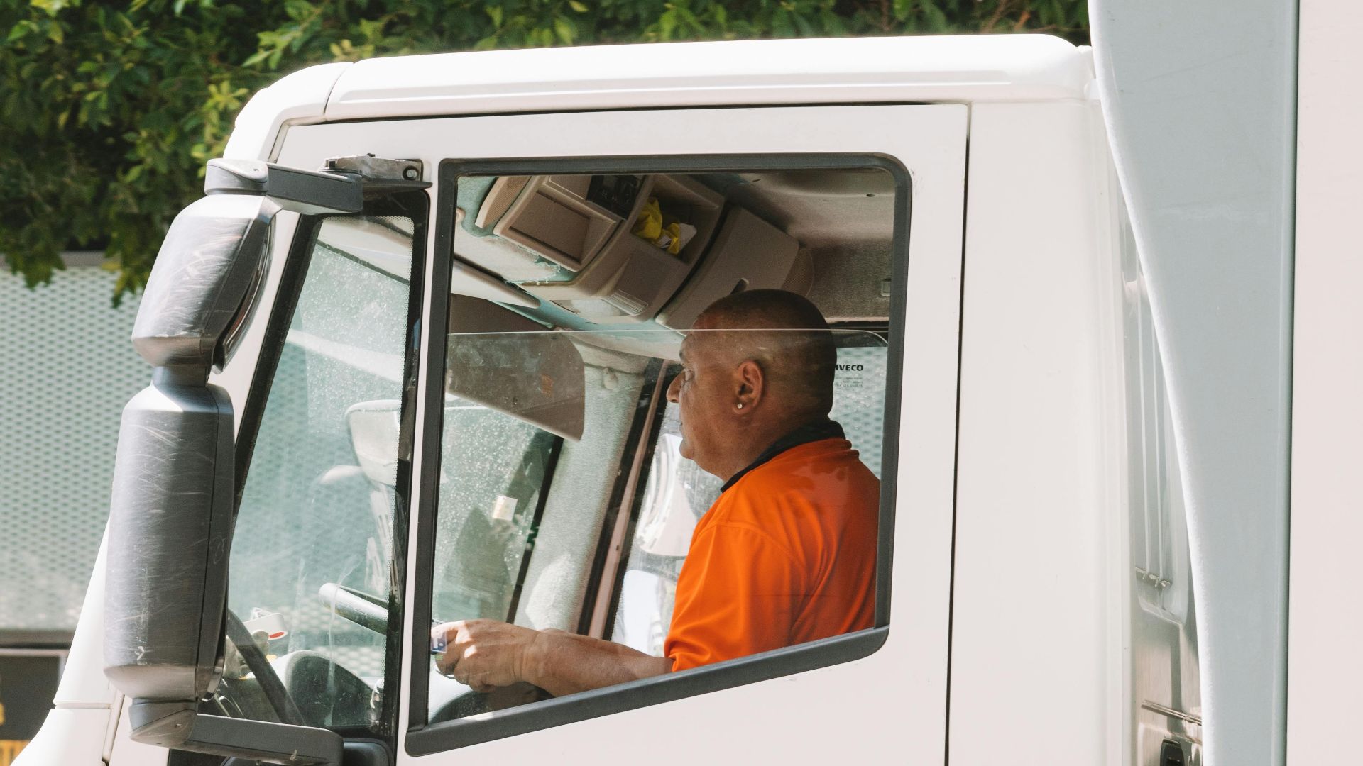 Driver in an urban truck, servicing streets in Valencia.