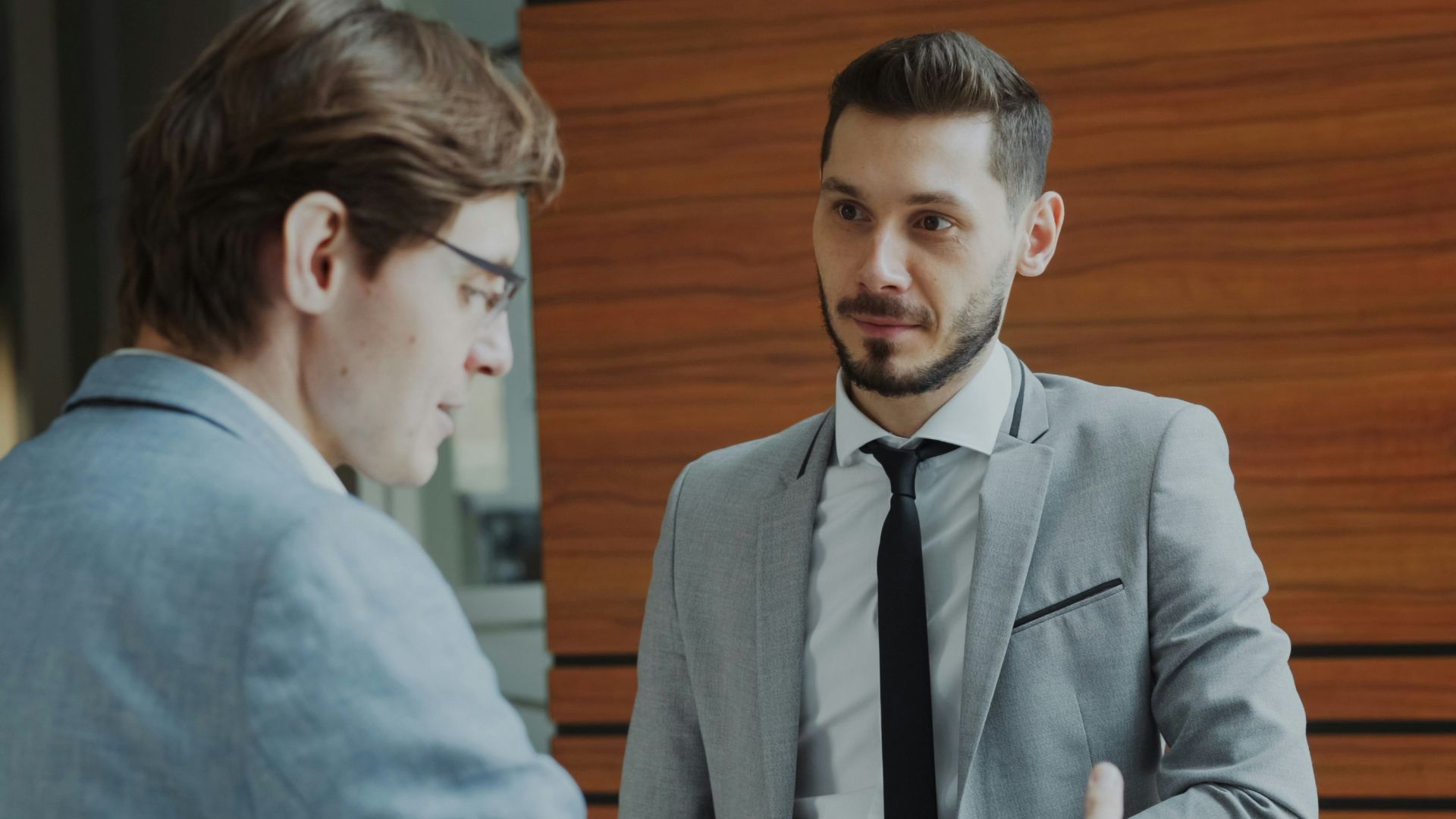 Two businessmen shaking hands in modern office