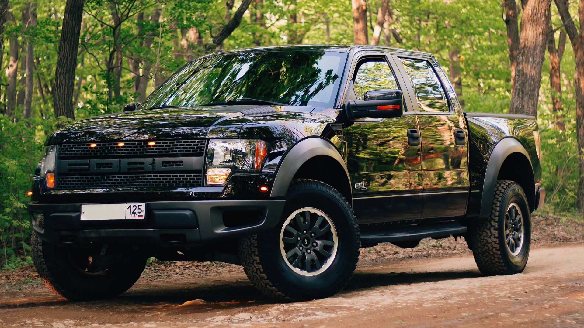 black and yellow chevrolet crew cab pickup truck parked on dirt road during daytime