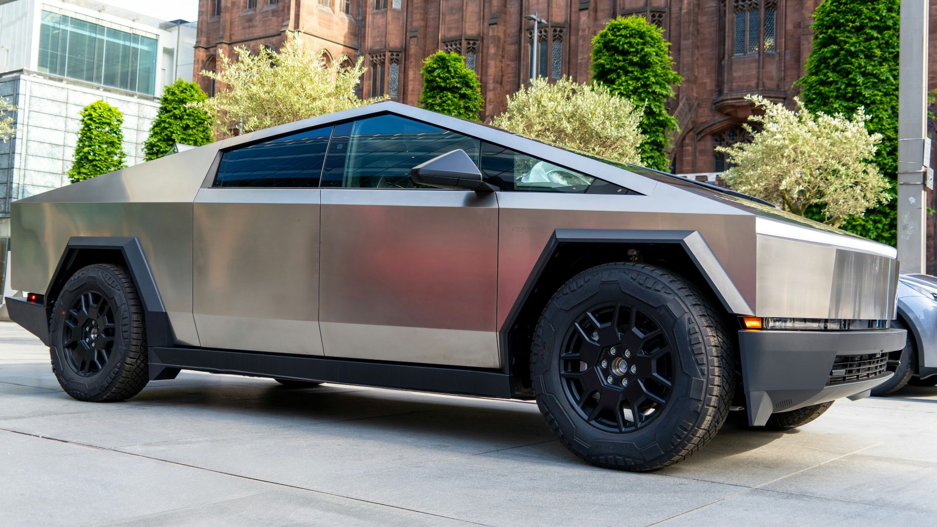 a futuristic car parked in front of a building
