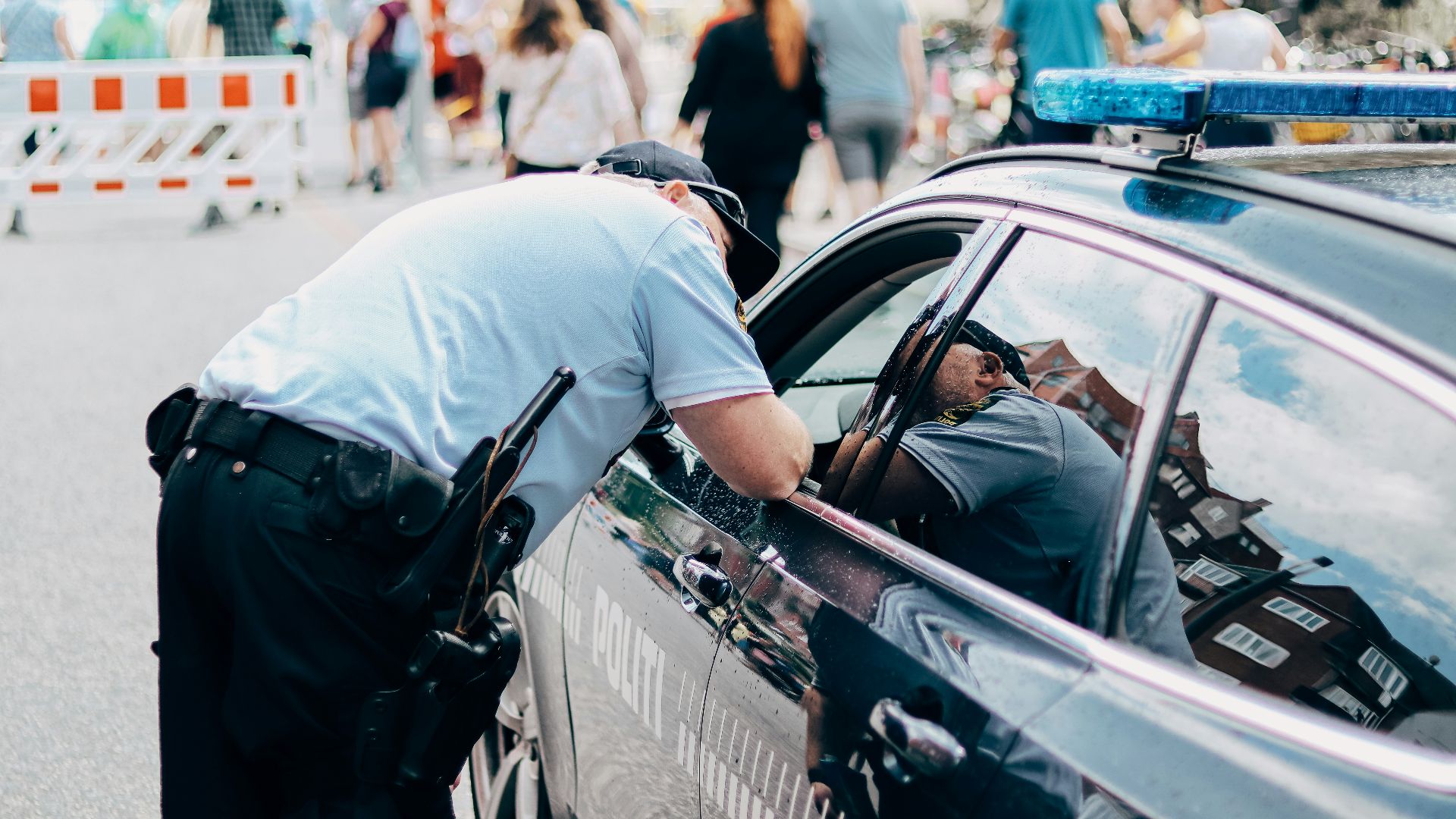 a police officer leaning into a police car