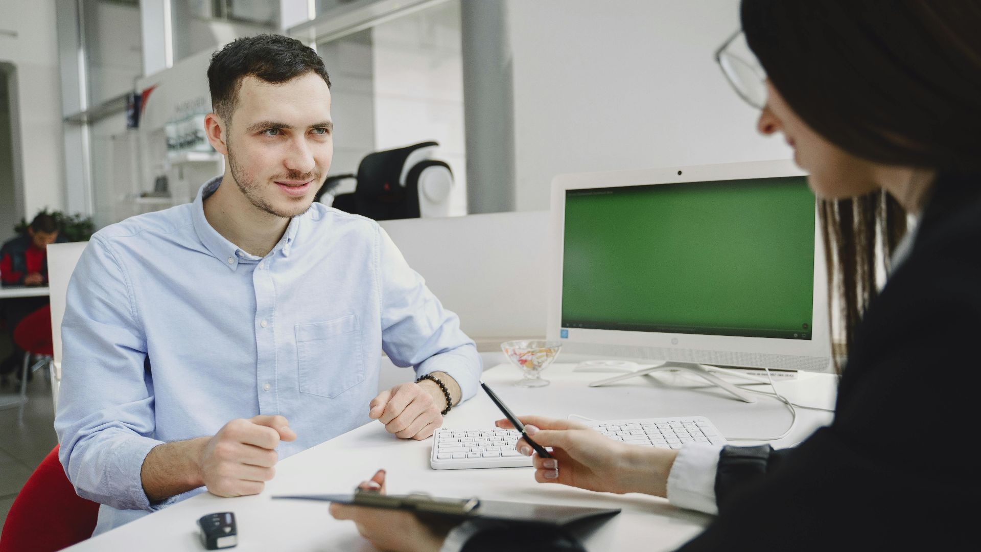 A business meeting between two office professionals, discussing strategies in a modern office.