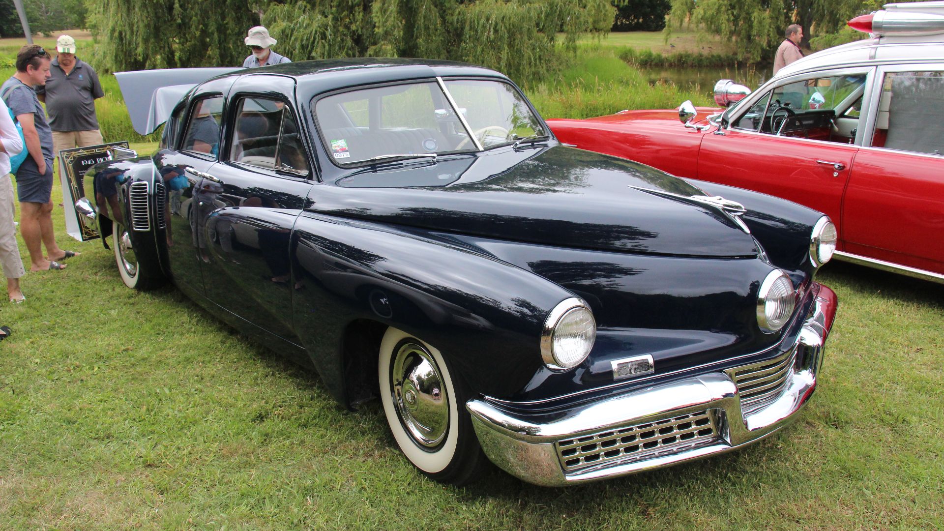 Waltz Blue. 
The Tucker 48 (named after its model year) is an automobile conceived by Preston Tucker and briefly produced in Chicago in 1948. Only 51 cars were made before the company ceased operations on March 3, 1949, due to negative publicity initiated by the news media.
The Tucker was designed as a very safe car with innovative features and modern styling. It had a rear mounted water-cooled aluminum block flat-6 rear engine, disc brakes, four-wheel independent suspension, fuel injection, the location of all instruments within reach of the steering wheel, seat belts, and a padded dashboard. The most recognizable feature of the Tucker '48, was a third directional headlight (known as the 'Cyclops Eye'). Centrally located, it would activate at steering angles of greater than 10 degrees to light the car's path around corners.
The 1988 movie Tucker: The Man and His Dream is based on the saga surrounding the car's production.

Engine; 166hp horizontally opposed 334 cu in 6 cyl