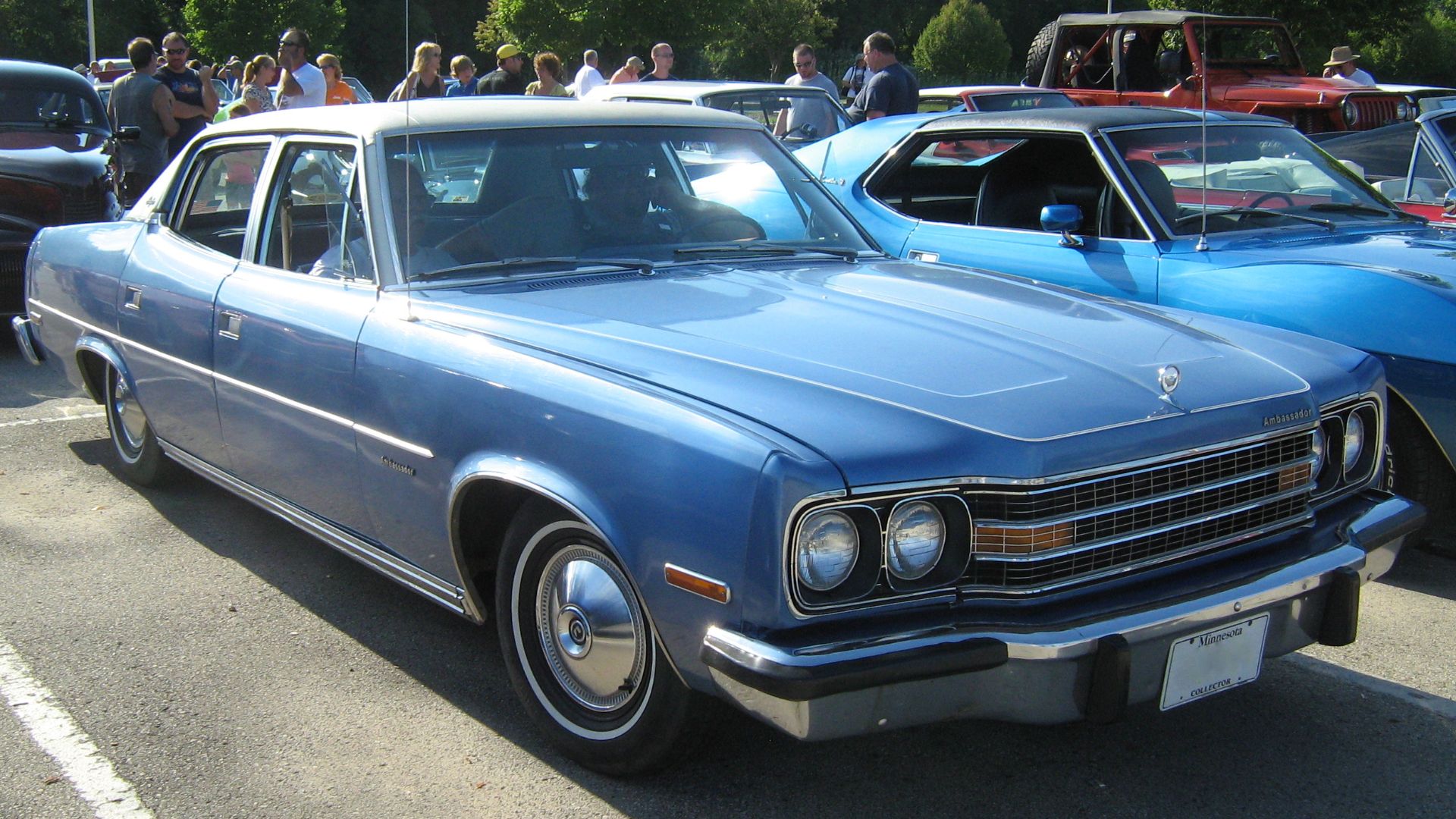 1974 AMC Ambassador Brougham four-door sedan finished in blue with a white vinyl covered roof and standard white bodyside and hood pin stripes. Built by American Motors in Kenosha, Wisconsin. All Ambassadors were equipped with V8 engines, automatic transmissions, power steering and disk brakes, air conditioning, radio, and numerous other standard comfort features.