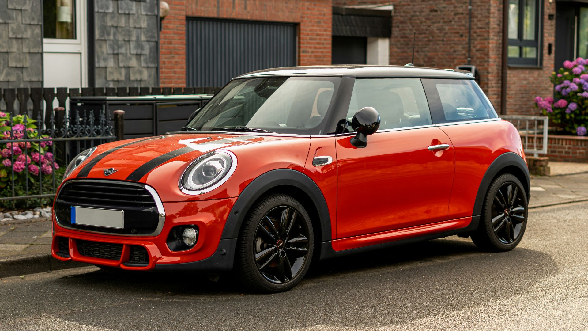 A red mini cooper parked on the side of the road