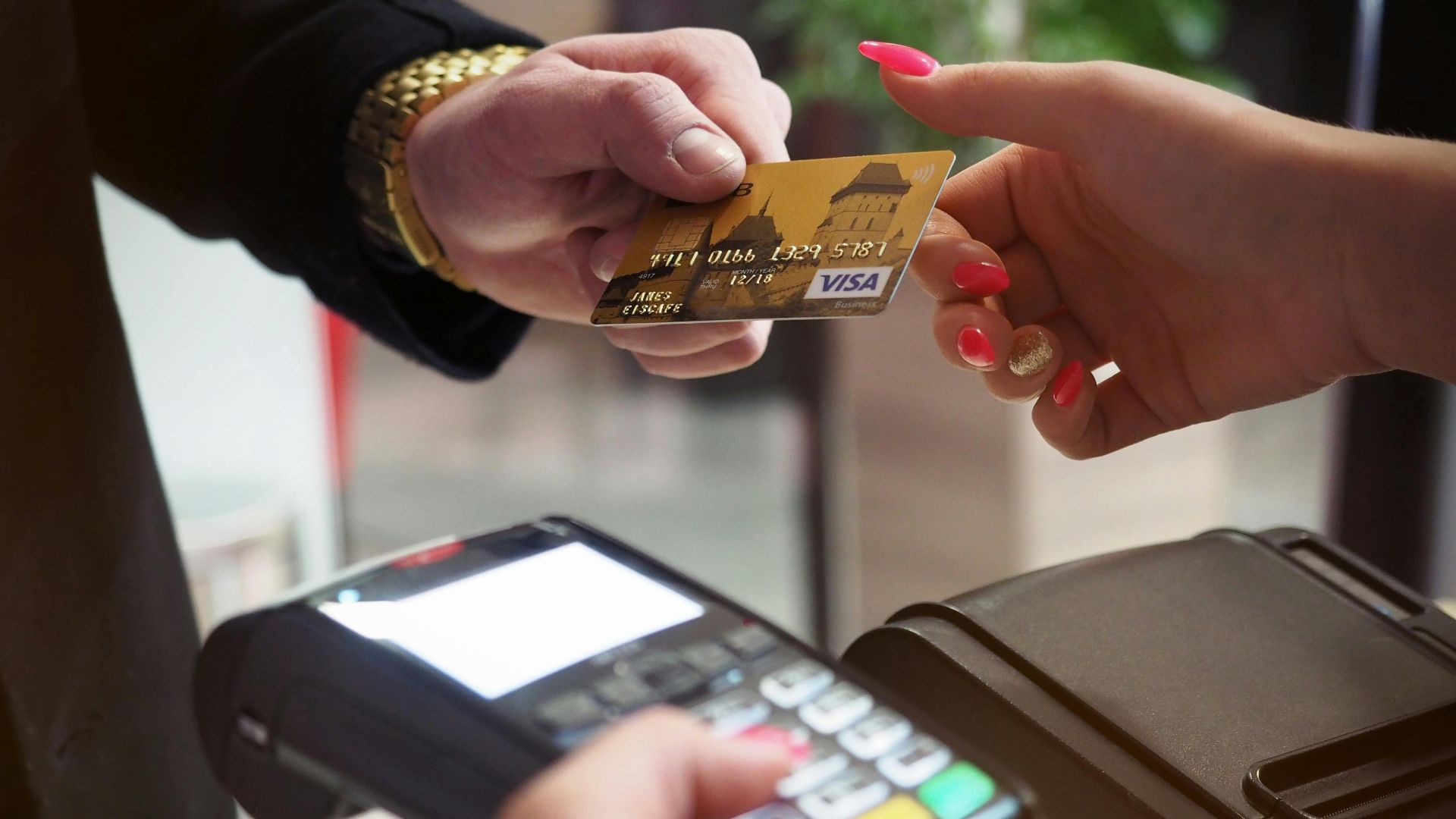 Close-up of a credit card payment being processed at a POS terminal.