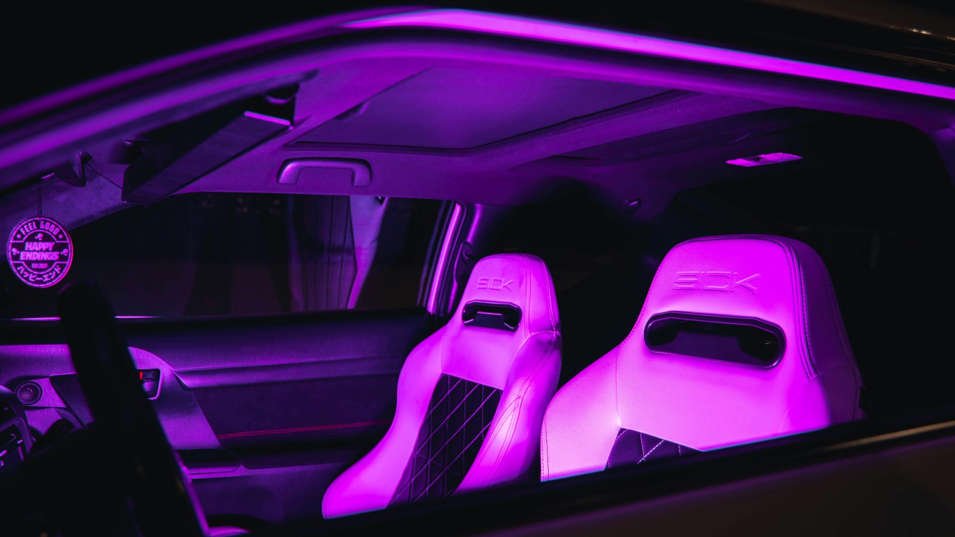 Luxury car interior with neon purple illuminated leather seats, creating a modern and vibrant ambiance.
