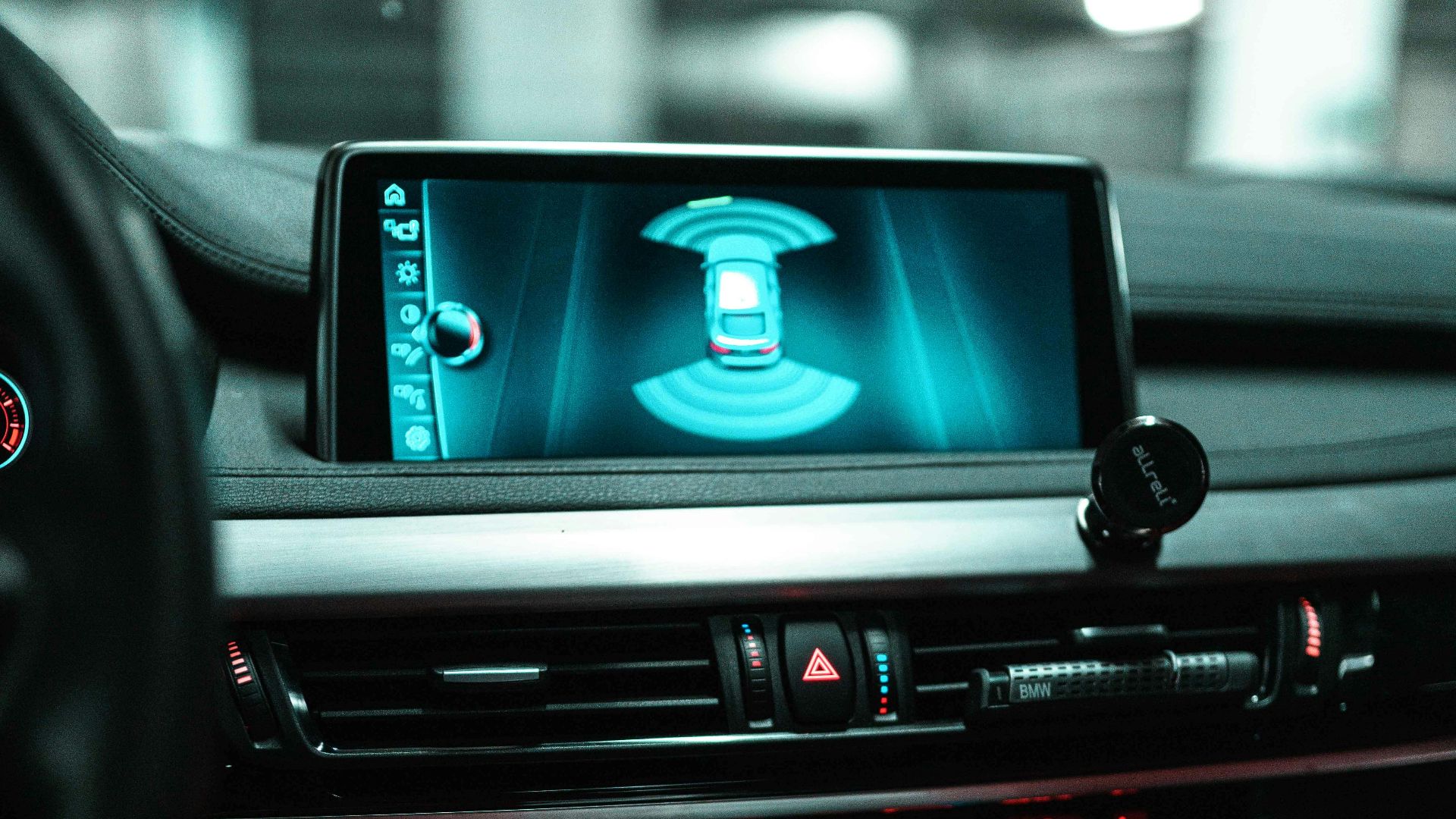 Close-up of a car dashboard with a digital screen and controls.