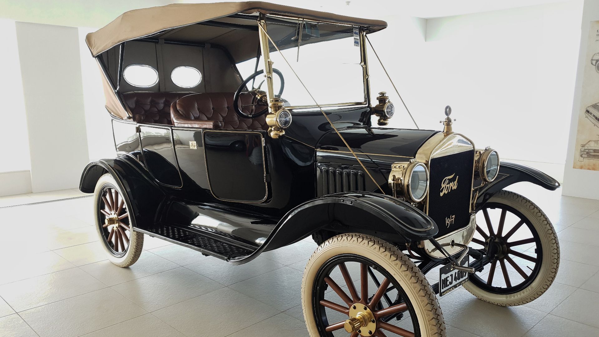 Ford (Model T 1917). (This car has a number of features which are quite nonstandard for 1917, such as the large plated radiator shell with apron, the gas-fueled headlamps, and the stays from the windshield to the front chassis.)