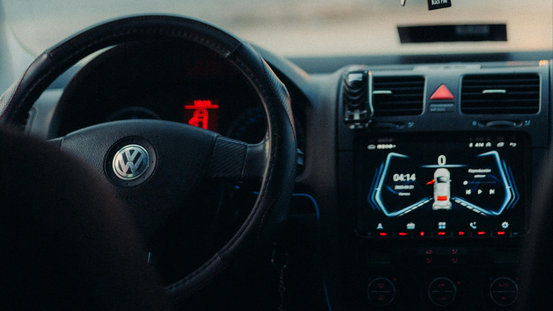 View of a car interior focusing on the dashboard and rearview mirror.