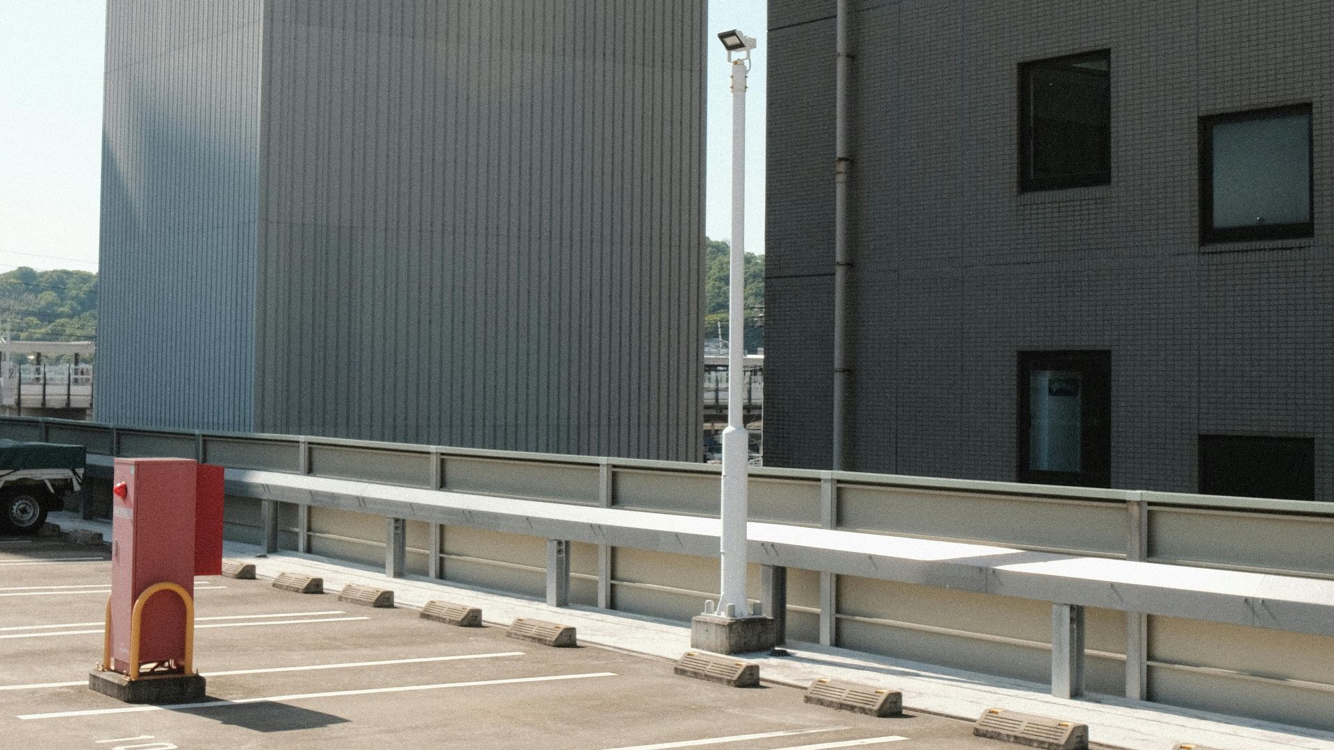 Clean rooftop parking lot with marked spaces in a modern city area, showing minimal activity.