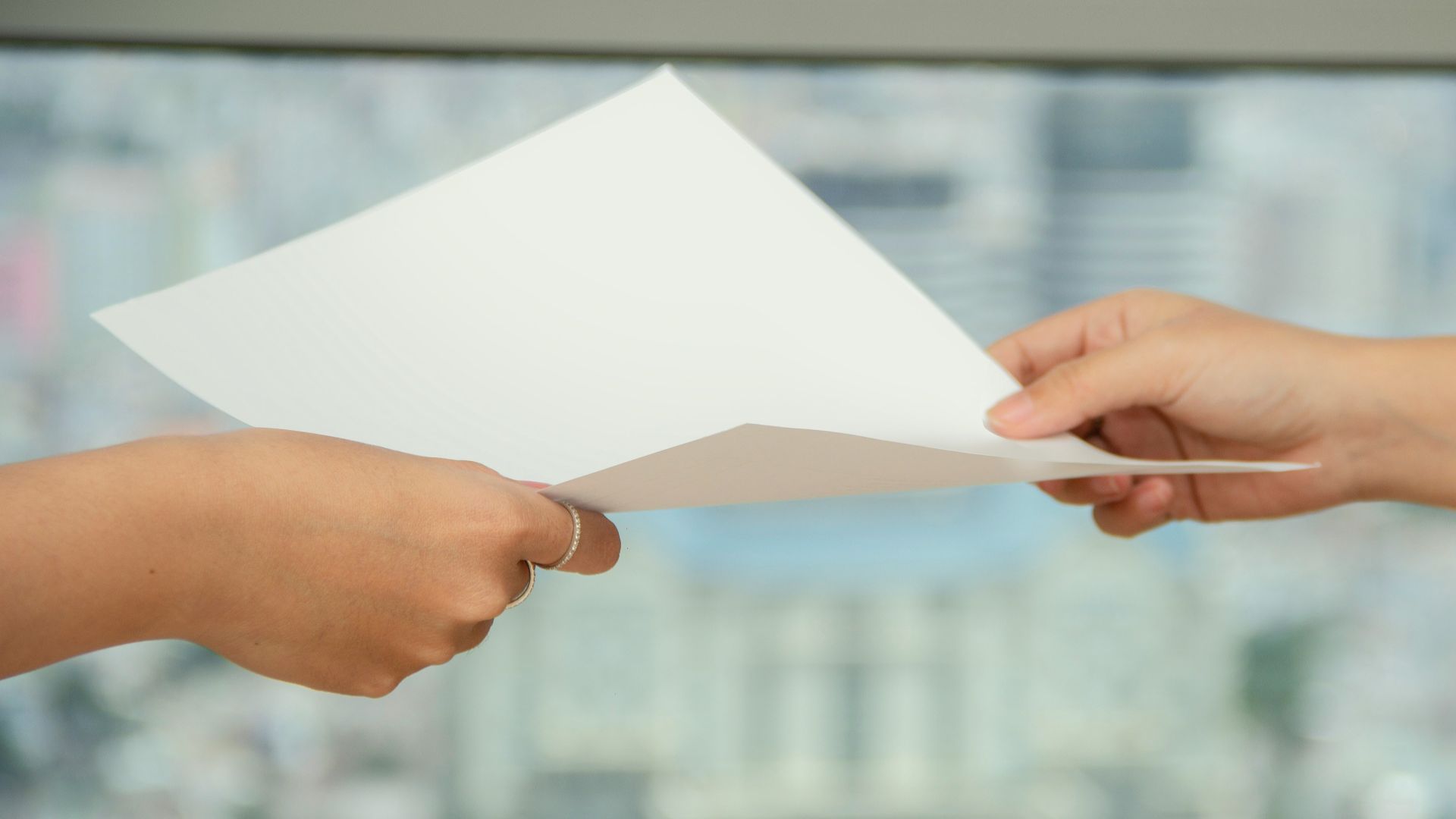 person handing over paper